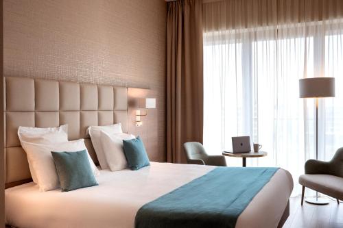 阿尔泽特河畔埃施Residhome Luxembourg Esch-Belval的一间设有大床和窗户的酒店客房