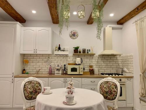克卢日-纳波卡Avram Iancu Apartment的厨房配有桌子、两把椅子和微波炉