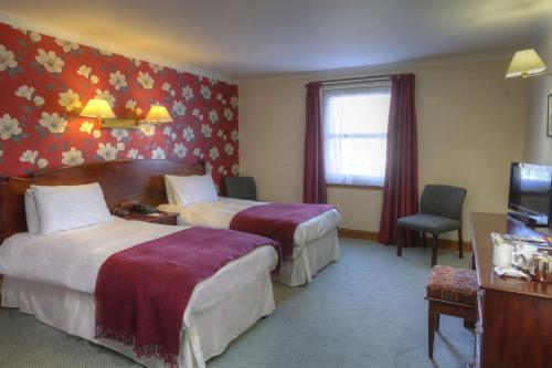 贝斯特韦斯特克里安拉利酒店客房内的一张或多张床位