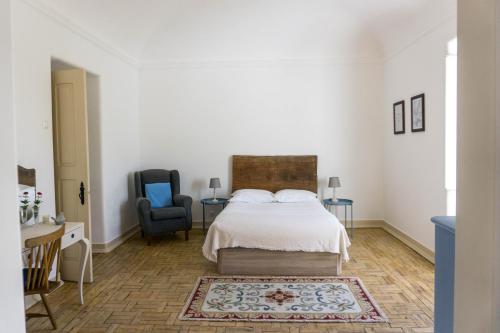 São BrissosTorre da Giesteira的白色卧室配有床和椅子