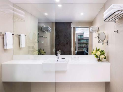 吉朗吉朗诺富特酒店的白色的浴室设有水槽和镜子