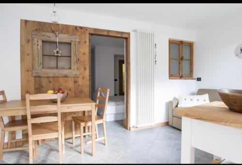 博尔米奥CASA CARCENTINA的厨房以及带木桌和椅子的用餐室。