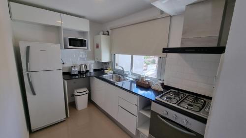 内乌肯Comfort Patagonia Inn的厨房配有白色冰箱和炉灶。