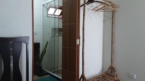 伊塔尼亚恩Cantinho do Nick的浴室设有镜子和玻璃淋浴间。