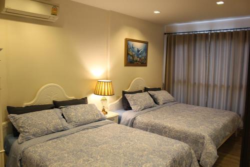 Rain ChaAm-HuaHin JN客房内的一张或多张床位
