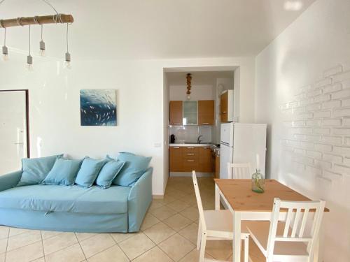 雷卡纳蒂港La perla del Porto的客厅配有蓝色的沙发和桌子