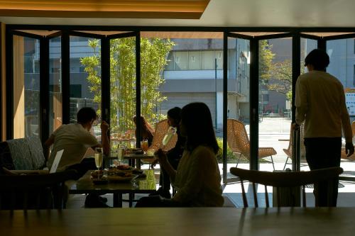 熊本FAV HOTEL KUMAMOTO的一群坐在餐厅桌子上的人