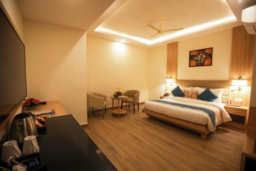勒克瑙Elora Lords Eco Inn , Lucknow的配有一张床和一张书桌的酒店客房