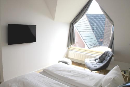 Sommerloft Norderney Ferienhaus客房内的一张或多张床位
