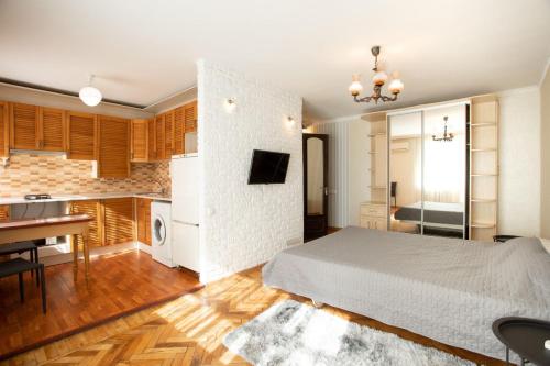 尼古拉耶夫Уютная квартира в центре的一间带白色床的卧室和一间厨房