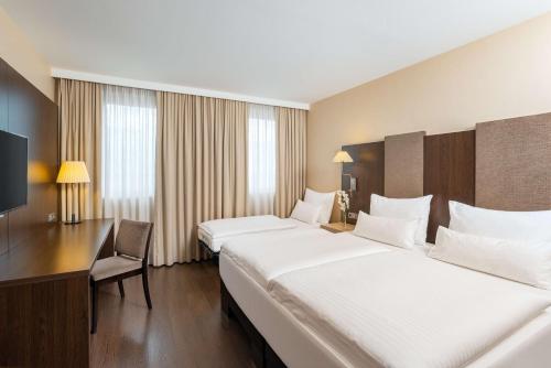 NH多瑙城酒店客房内的一张或多张床位