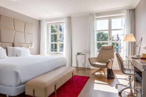 布鲁塞尔布鲁塞尔大萨布隆NH酒店的卧室配有一张白色大床和一张书桌