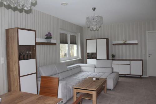 SanitzOstsee-Luxus-Ferienwohnung Sanitz的客厅配有白色的沙发和桌子