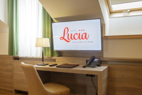 维也纳露西亚酒店的电视、桌子、椅子和电话