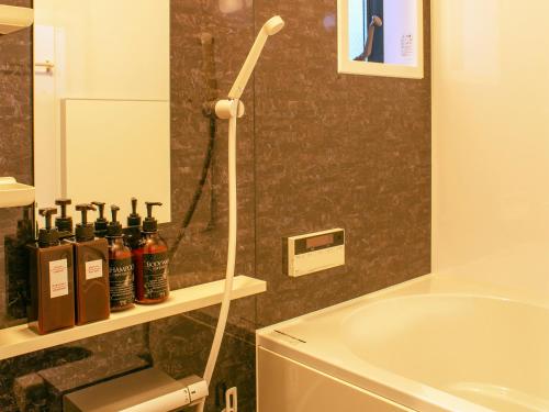 名古屋武士度假屋的设有带浴缸和淋浴的浴室。