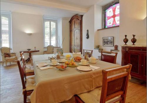 巴涅尔德比戈尔Maison d'hôtes Le Couvent的用餐室配有餐桌和食物