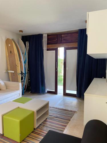 乌鲁奥App Alby KiteVillage的一间带一张床的客厅和一间带冲浪板的房间