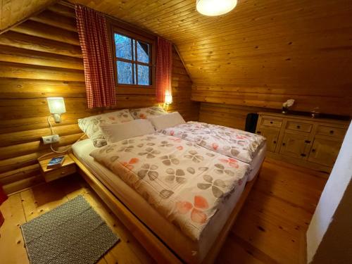 BaierdorfFerienhütte Bosic的小木屋内一间卧室,配有一张床