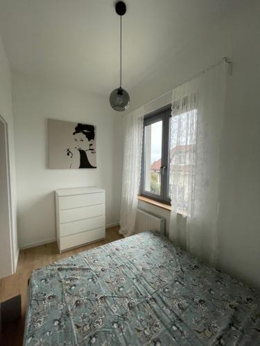 科莫尔尼基Apartamenty Komorniki的白色的卧室设有床和窗户