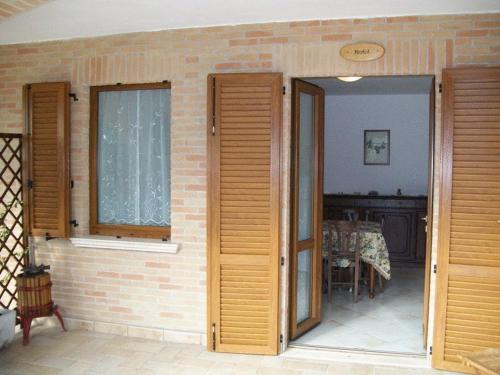 蒙特法尔科拉科里纳德尔萨格瑞恩提诺酒店的一间设有两扇门和砖墙的房间