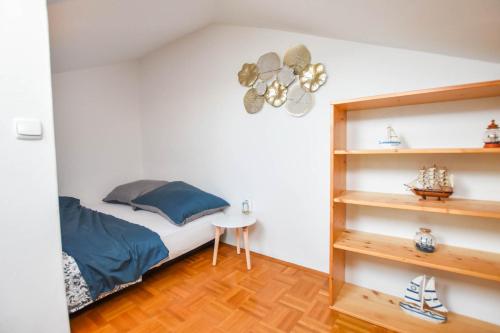比奥格勒·纳·莫鲁Apartment Emil的一间卧室设有一张床和一个书架