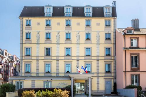 斯特拉斯堡贝斯特韦斯特PLUS别墅酒店的前面有两面旗帜的大建筑