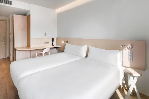 马拉加B&B HOTEL Málaga Centro的一张大白色的床,位于酒店客房内