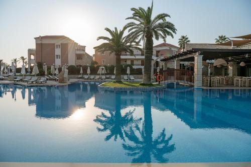 普拉塔尼亚斯Caldera Creta Paradise的一座棕榈树和建筑的大型游泳池