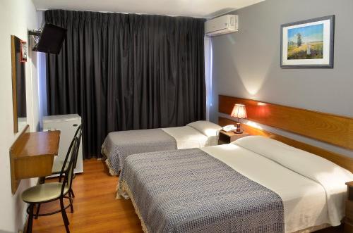 蒙得维的亚希斯潘诺酒店的酒店客房配有两张床和一张书桌