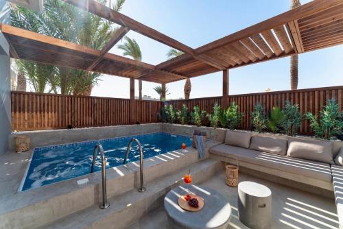 普拉索尼西Oasis Hotel Prasonisi的后院的游泳池,带凉棚