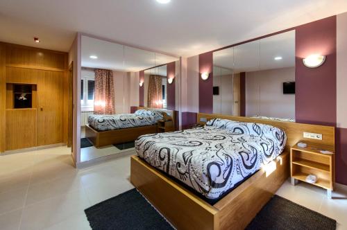 Iboya坎昆阿维莱斯汽车旅馆的一间卧室配有一张大床和镜子