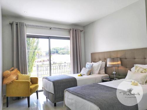 奎特里拉Pine Hills Resort的一间卧室设有两张床、一把椅子和一个窗户。