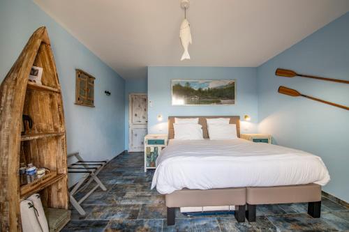 索尔格河畔利勒马斯塞拉芬旅馆的一间卧室设有一张大床和蓝色的墙壁