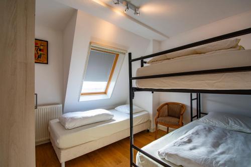 卡兰茨奥赫Penthouse Duinerei- Groote Keeten的客房设有两张双层床和一扇窗户。
