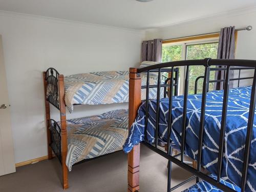 Marlo8 Sailor's Retreat的一间卧室设有两张双层床和一扇窗户。