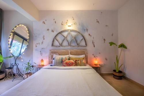 瓦加托La Casa - Stunning 1BHK Apartment - Vagator, Goa By StayMonkey的卧室配有一张大白色床和窗户