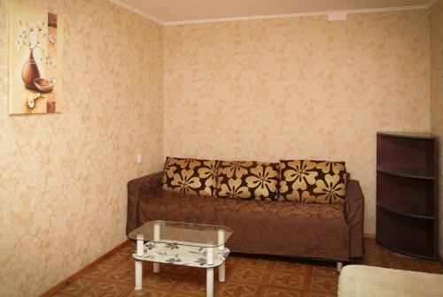 第聂伯罗Pobeda Apartment的客厅配有棕色沙发和桌子