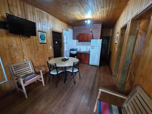 伊瓜苏港Morada Silvestre Iguazú的厨房配有桌椅和冰箱。