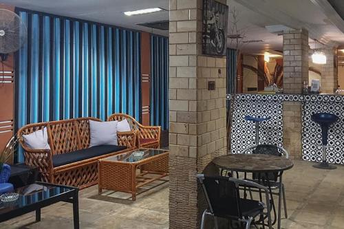Sungai LutusRocky Guest House Syariah Mitra RedDoorz的客厅配有沙发和桌子