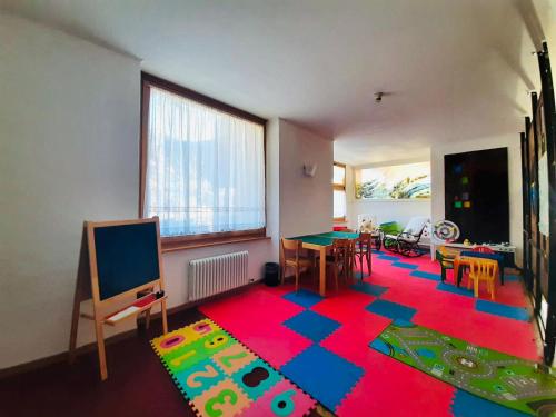 布吕松HG Hotel Italia的一间客厅,地板上铺着色彩缤纷的地毯