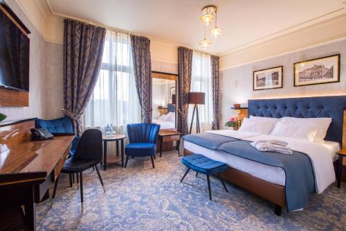 卡托维兹卡托维兹戴梦德广场酒店的酒店客房配有一张特大号床和一张书桌