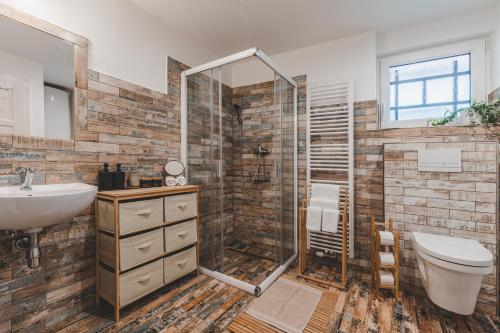 捷克克鲁姆洛夫Konekt Apartment的带淋浴、卫生间和盥洗盆的浴室