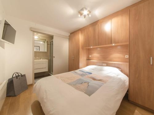 布列登Apartment Sea Breeze by Interhome的一间卧室配有一张大床和木制橱柜。