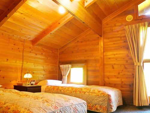 北塩原村兄弟宾馆的小木屋内一间卧室,配有两张床