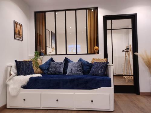 杜埃Le petit Dubaï的客房内的白色沙发,配有蓝色枕头