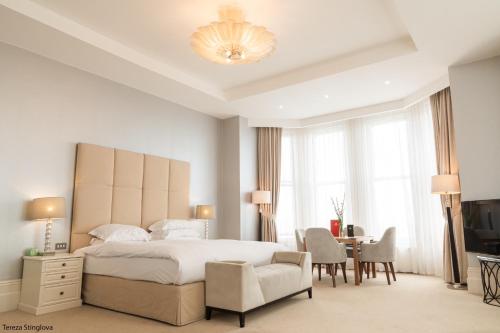 伊斯特布恩The Chatsworth Hotel的一间卧室配有一张床、一把椅子和一张书桌