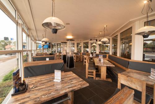 德尔宁恩登布尔特弗兰斯酒店的一间带木桌和长椅的餐厅