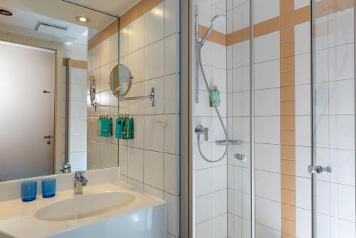 科隆Essential by Dorint Köln-Junkersdorf的一间带水槽和淋浴的浴室