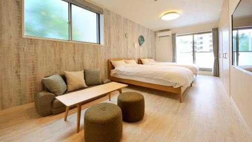 大阪RakutenSTAY x Shamaison Osaka Dekijima - 304的一间卧室配有一张床、一张沙发和一张桌子