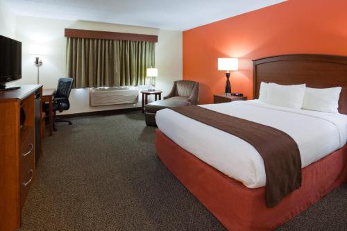 Virginia弗吉尼亚阿美瑞辛别墅及套房酒店的酒店客房设有一张大床和一台电视。